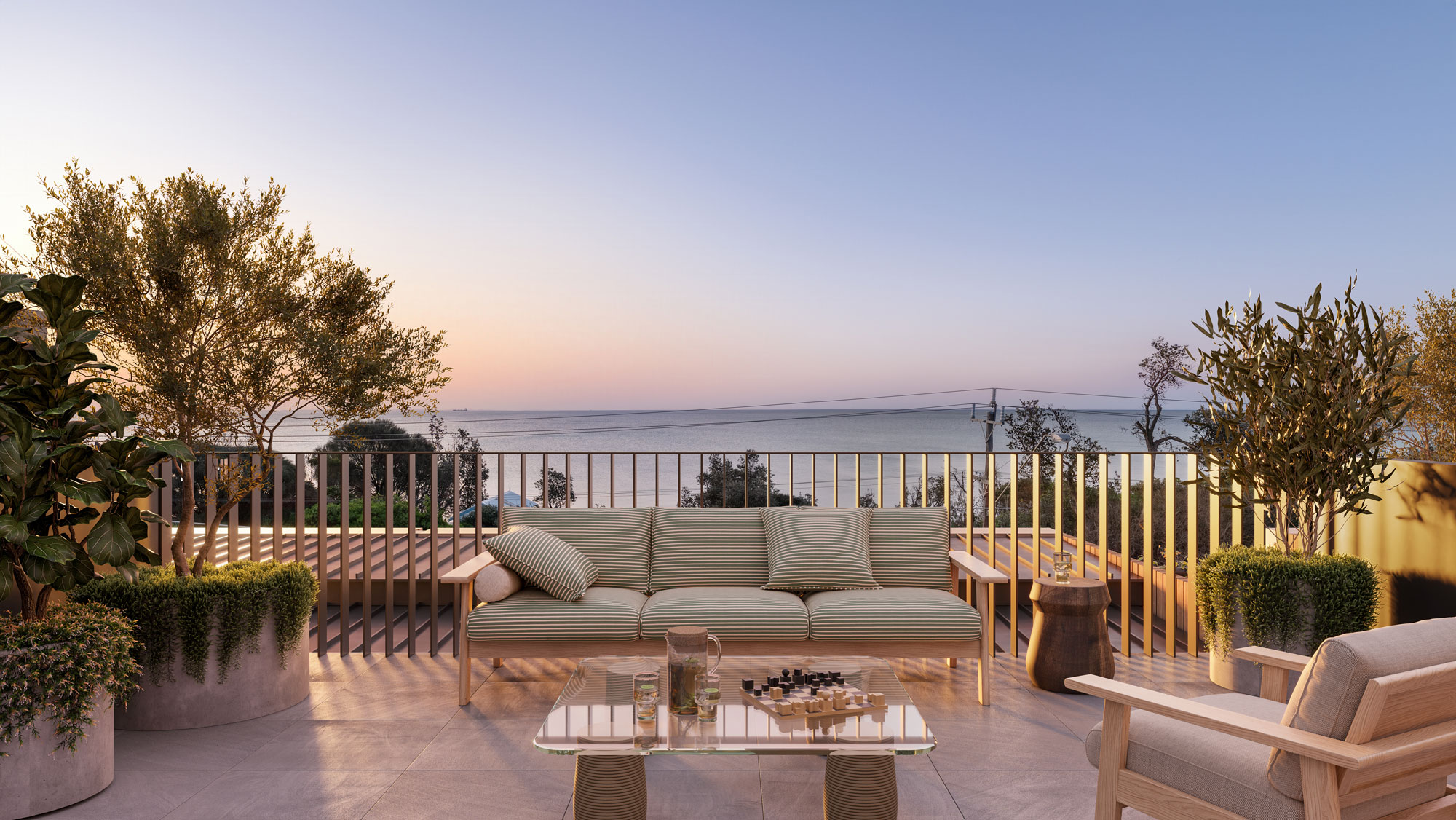 Luxurious balcony terrace overlooking a calm ocean at sunset. The terrace is designed for relaxation, featuring a stylish outdoor furniture and lush potted landscaping.