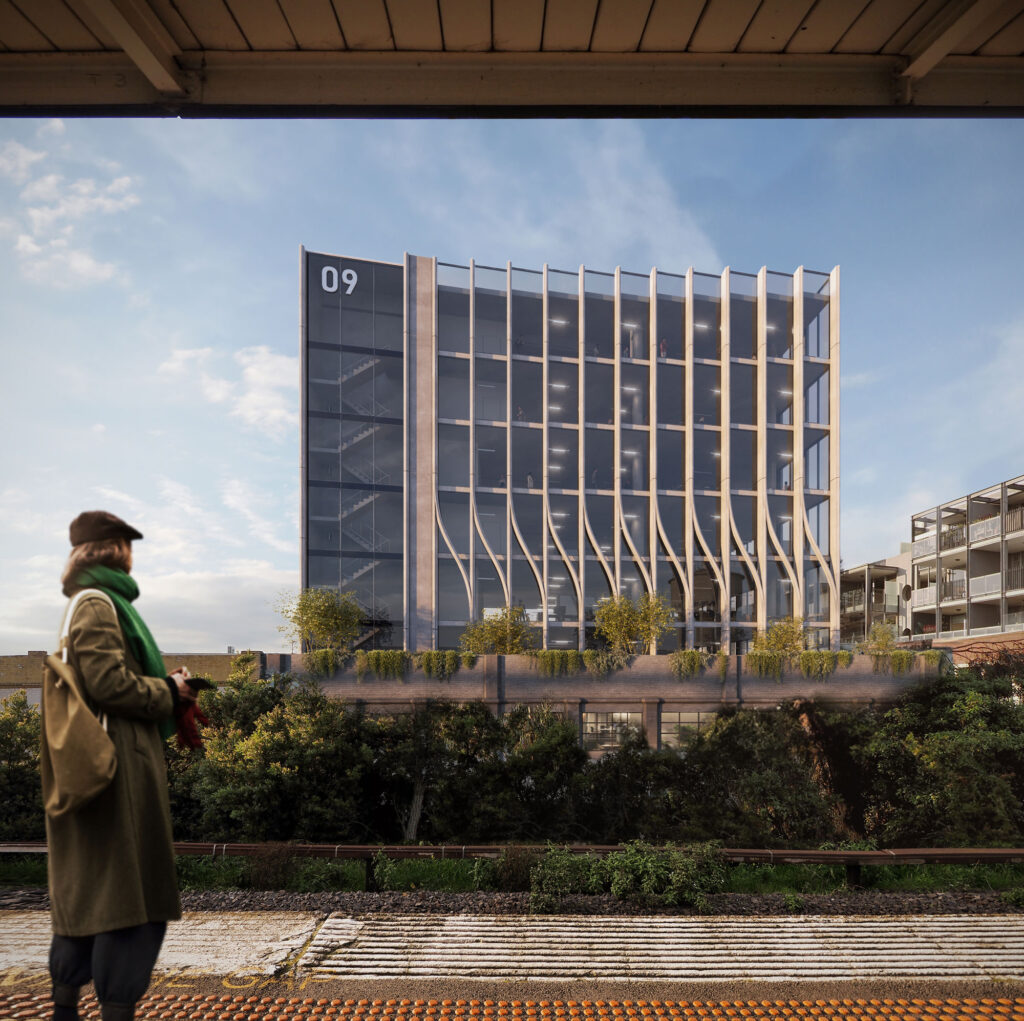 Train station over looks modern architectural building with curved concrete detailing and glass windows